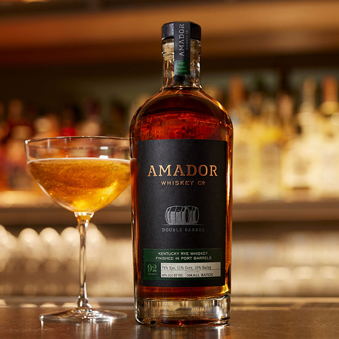 Color image of a bottle of Amador Whiskey Co whiskey with a cocktail on a bar